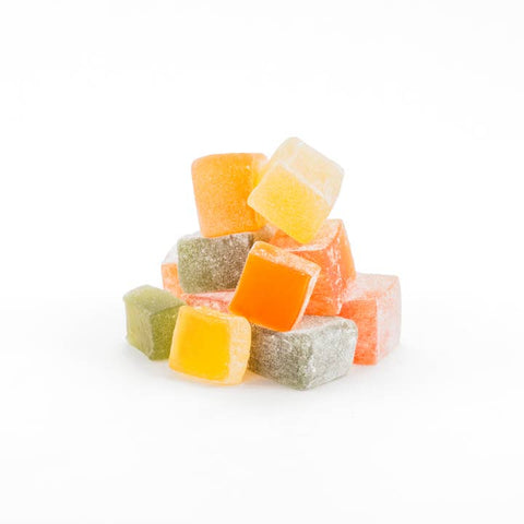 Assorted colored jelly cubes on a white background