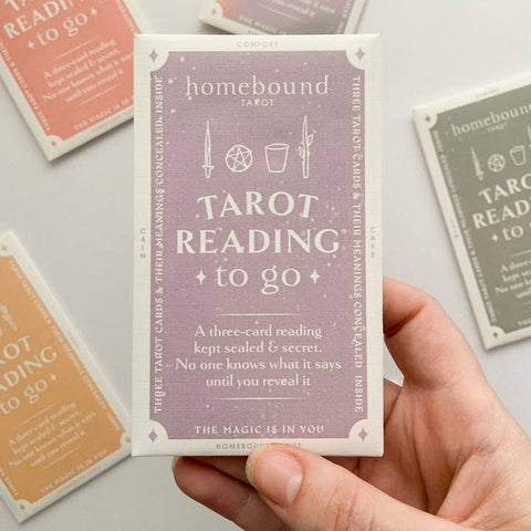 Homebound Tarot card set with a hand holding one of the cards.