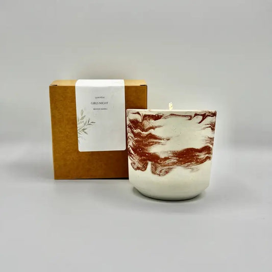 soy wax candle in cement vessel with red tones