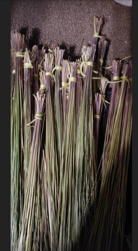 Bundles of dried herbs tied together on a dark background