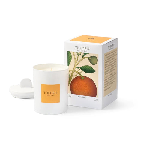 orange honey candle in white jar with orange box