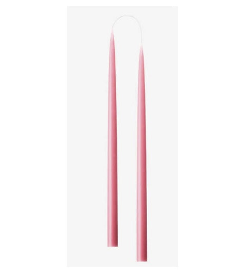 two pink taper candles with white wicks, arranged in two pairs on a light gray background.