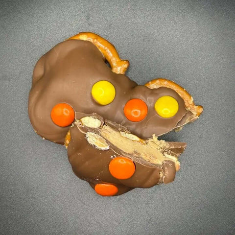 Chocolate Coated Pecan Pretzel Bites in peanut butter