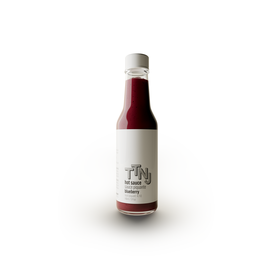 blueberry hot sauce in glass bottle and white label