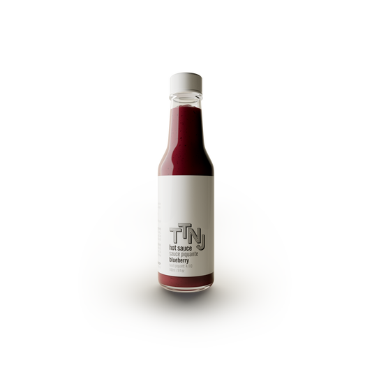 blueberry hot sauce in glass bottle and white label