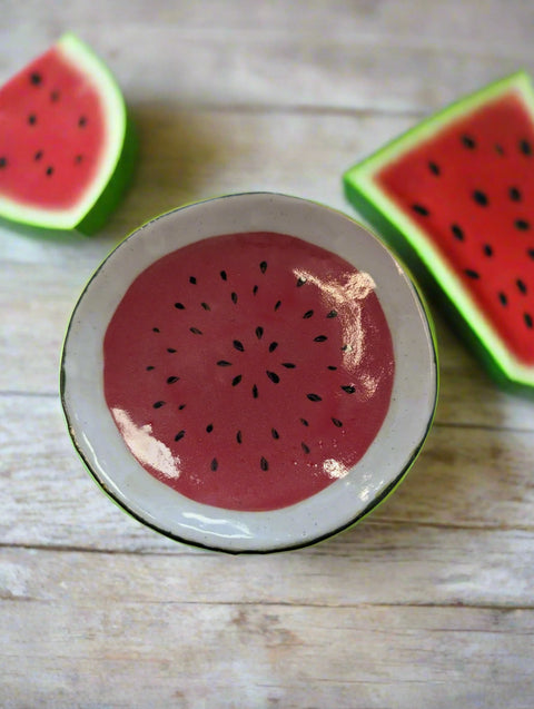 Round ceramic dish with watermelon pattern on a white background