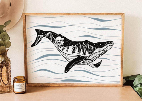 Framed artwork of a whale on wavy lines with a candle and plant in the background