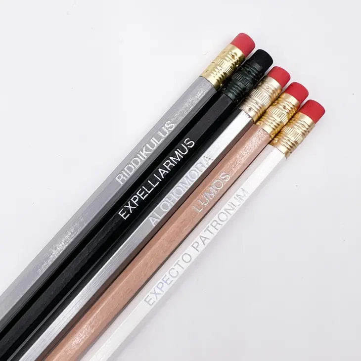 5 pencils with spell charms written on